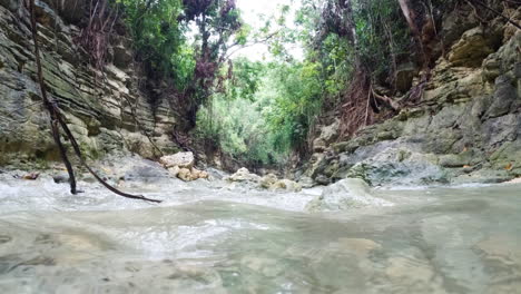 Cinemativ-slow-motion-footage-of-a-river-flowing-through-tropical-rainforest-in-Philippines,-Asia,-120-FPS