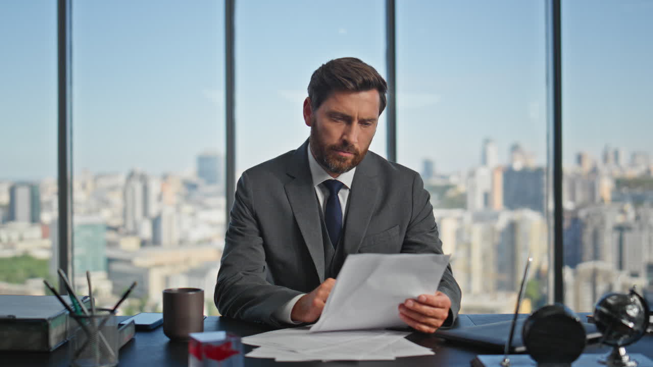 direttore aziendale rapporto di studio in un ufficio di vetro. uomo barbuto ceo lettura di documenti