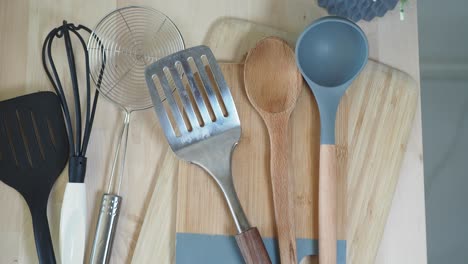 various kitchen utensils on a wooden surface