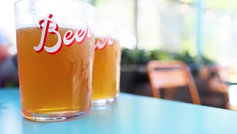 two beer glasses on a table in london