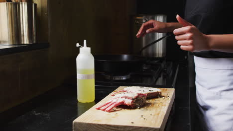 biracial male chef preparing a dish and smiling