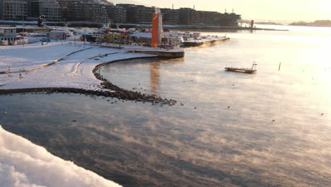 misty waters on a sunny winter morning on the coast of oslo in norway