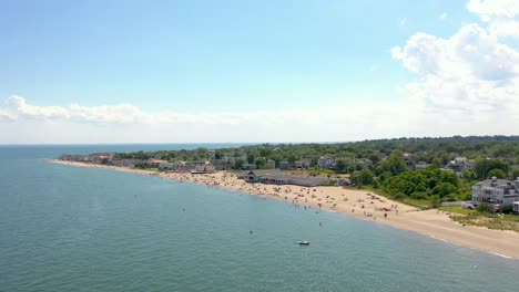 Lush-coastal-sunny-Penfield-Beach-in-Fairfield,-CT-idyllic-aerial-view-above-turquoise-shoreline-travel-destination