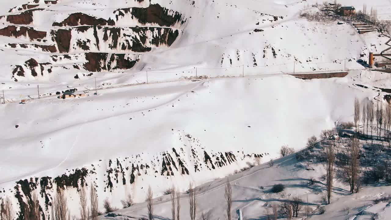 Slow motion mountain view of shemshak. Drone shot of snow mountains