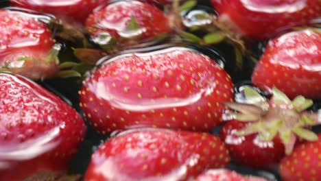 strawberry-extreme-close-up-of-healthy-fruit-food-floating-in-clear-water-after-picking