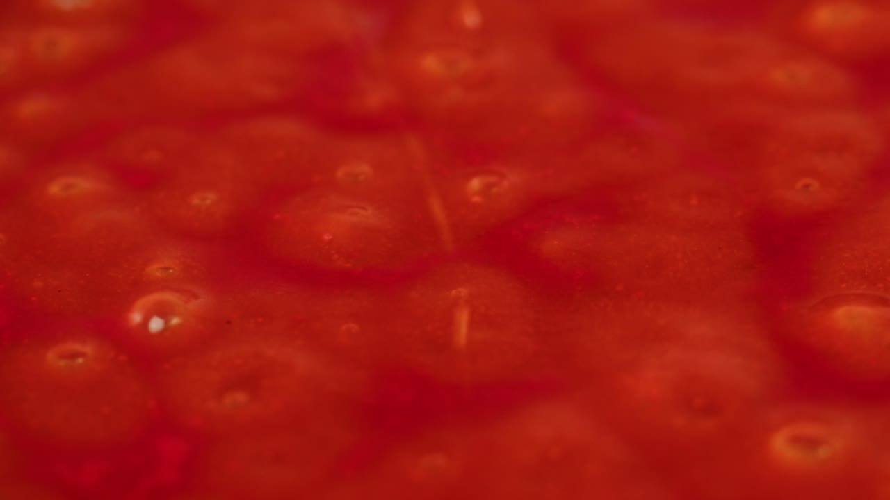 Boiling tomato sauce on a frying pan close-up. Cooking tomato sauce or soup. Traditional Italian Mexican Asian dish. High quality studio shot for cafe, restaurant close up. Marinara sauce for Italian pasta