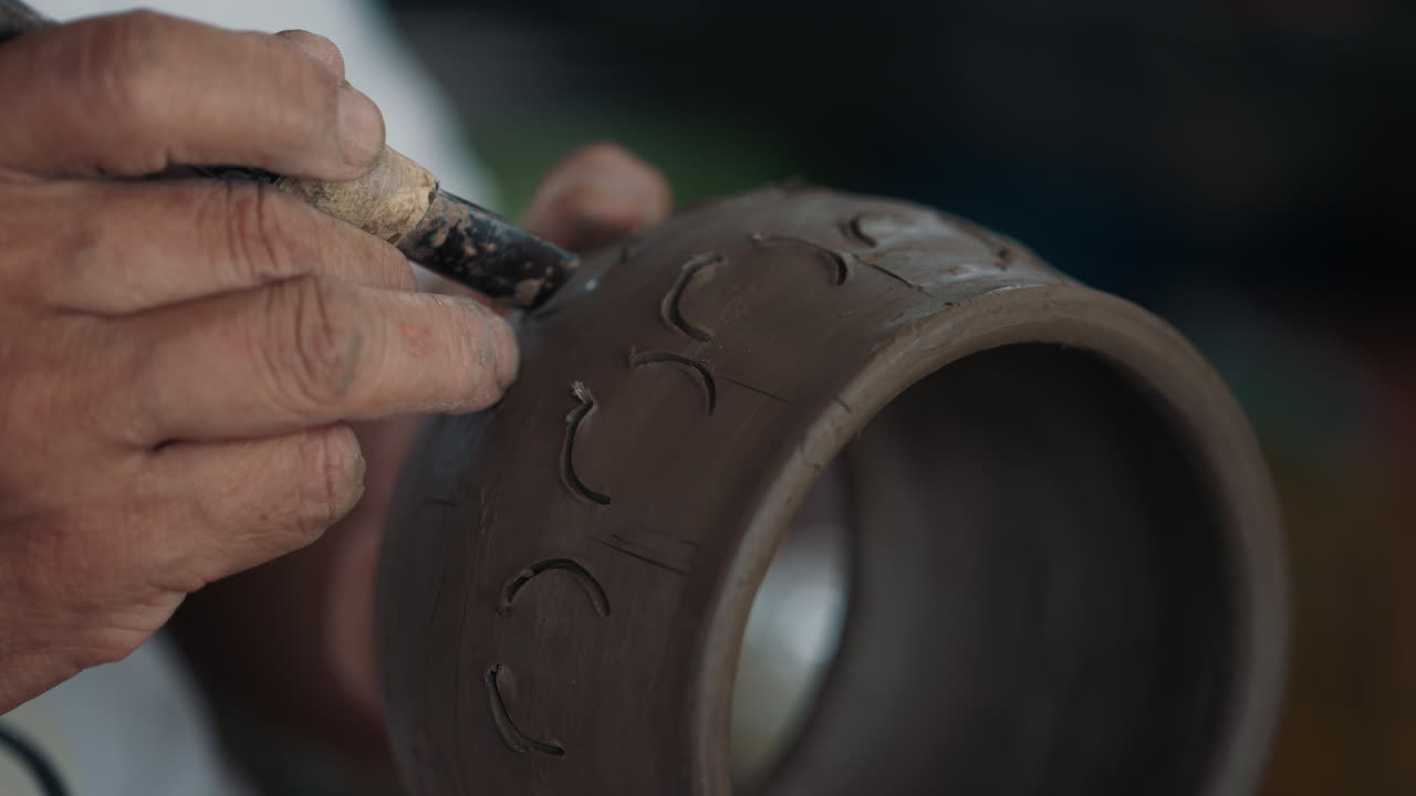 Artisan Carving a Clay Pot