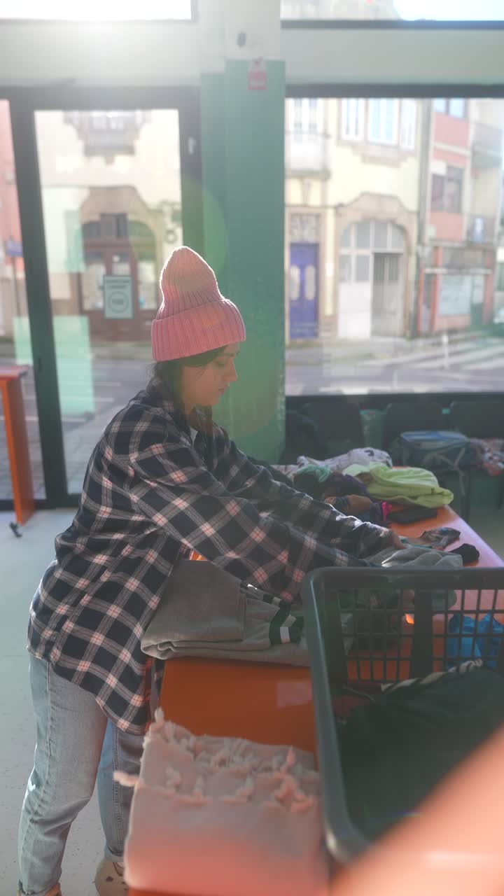 adolescente clasificando la ropa donada