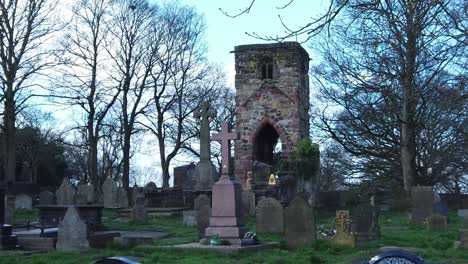 Historic-Windleshaw-Chantry-stonework-tower-and-cemetery-slow-motion-through-ruins-against-blue-sky