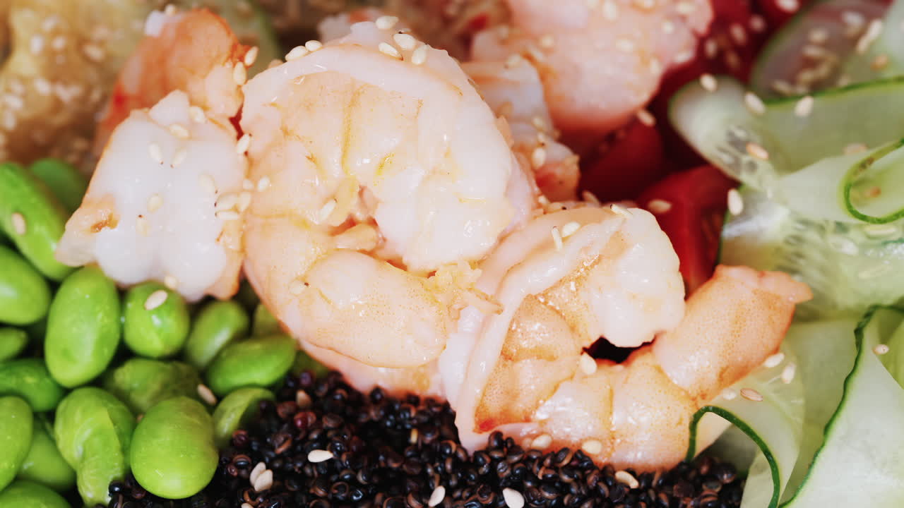 Healthy shrimp bowl with tomatoes, quinoa, edamame, and zucchini