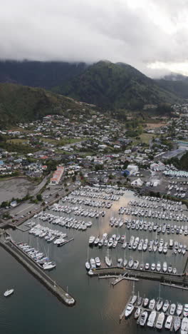 vertical drone shot overlooking the waikawa marina and town, in new zealand