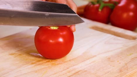 tomato slicing demonstration on a wooden board