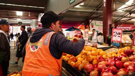 staff arranging fruits at melbourne market stall