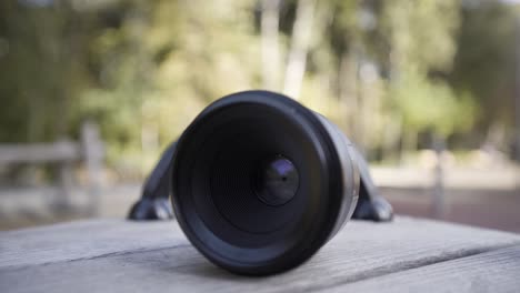 close-up of a camera lens on a wooden table