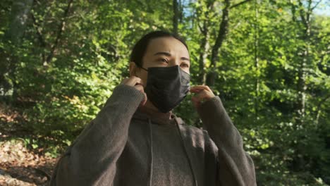 girl taking off mask in nature and breathe fresh air