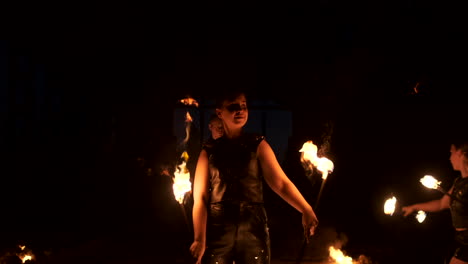 Slow-motion:-Fire-show-in-the-hangar-show-three-female-artist-and-a-man-with-flamethrowers