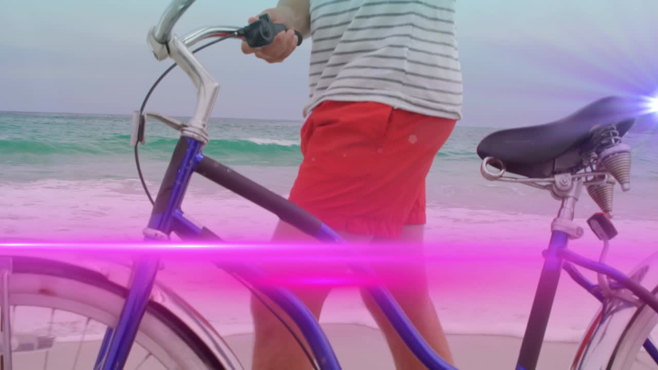 해변에서 자전거를 달리는 남자를 가로질러 움직이는 분홍색 빛 의 애니메이션