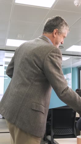 Male boss giving documents to female office workers