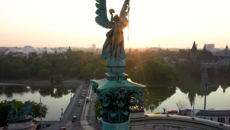 drone footage of the empty heroe's square in budapest, hungary at the time of the covid virus. early morning at the sunrise in spring.
drone circles slowly right around the statue with nice lensflare.