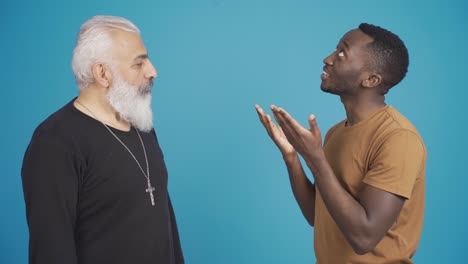 african muslim man and christian man inform each other about their religion and friendly smiling at camera.