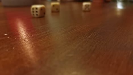 numerous dice rolling across a wooden table top