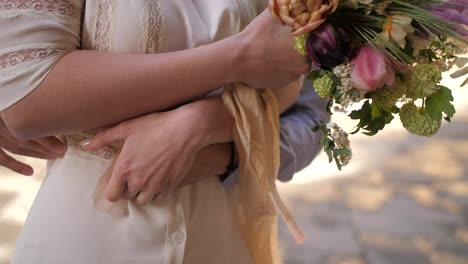 young newlyweds embracing, holding hands and tickling, closeup slow motion shot