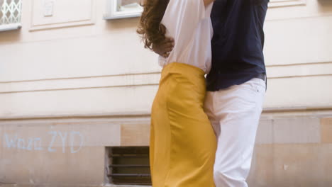 happy interracial couple dancing bachata in the old town street 3