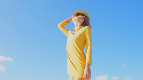 Low-angle-view-of-young-Caucasian-woman-standing-on-the-beach-4k