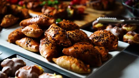 Crispy-baked-savory-dough-buns-on-bright-indoor-reception-table,-Czechia