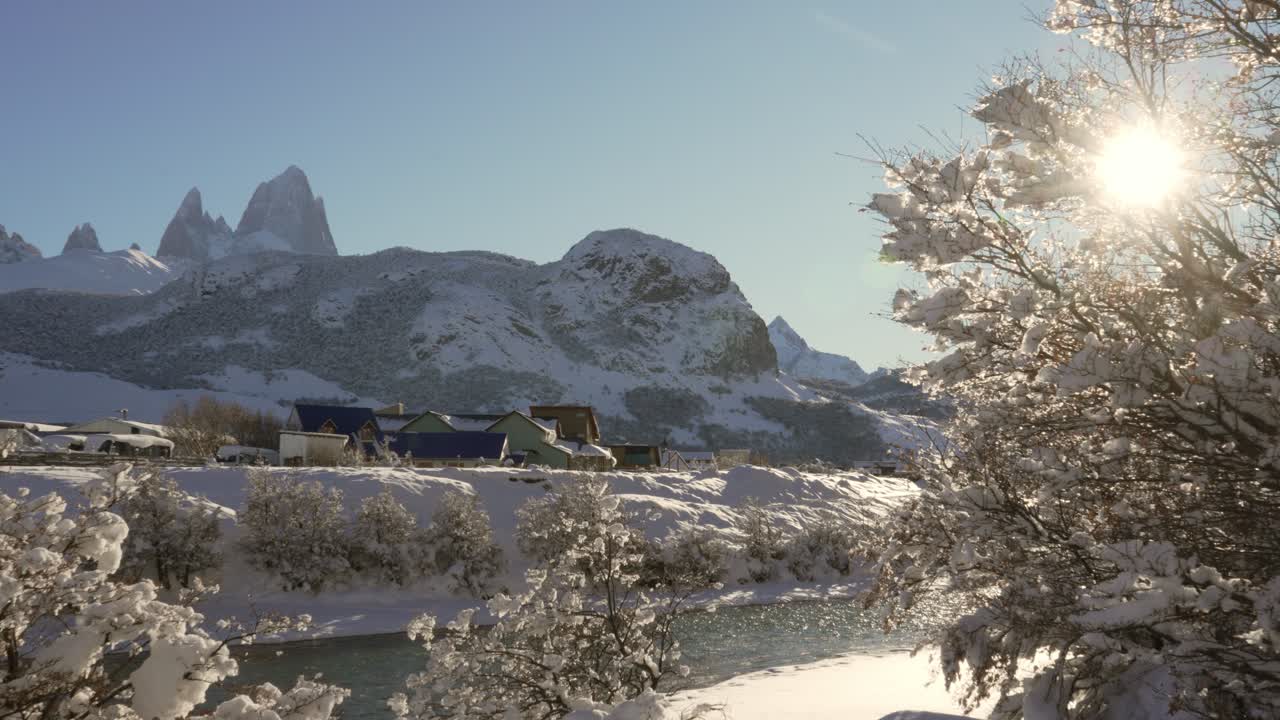 Stunning Winter Landscape in Patagonia: Snow-Covered Mountains, River, and Village