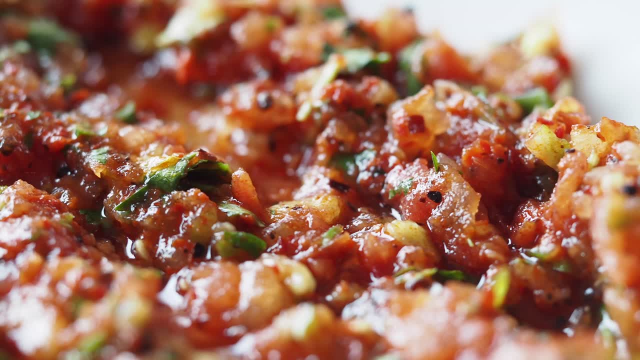 Close-up view of a red tomato sauce with herbs