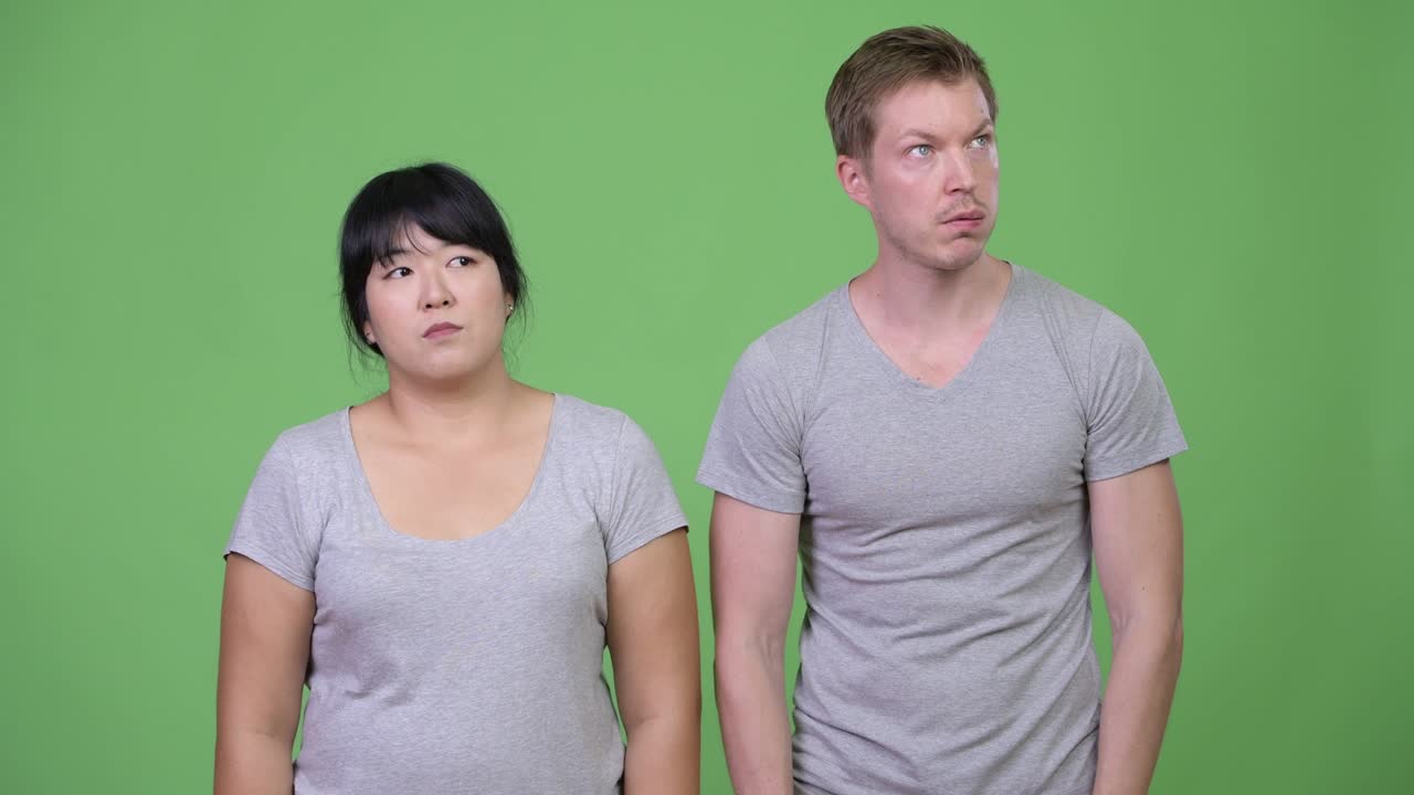 Young multi-ethnic couple looking bored together