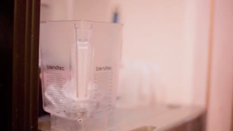 barman barista bartender pouring ice cubes in blender at a local cafe diner restaurant in mexico latin america