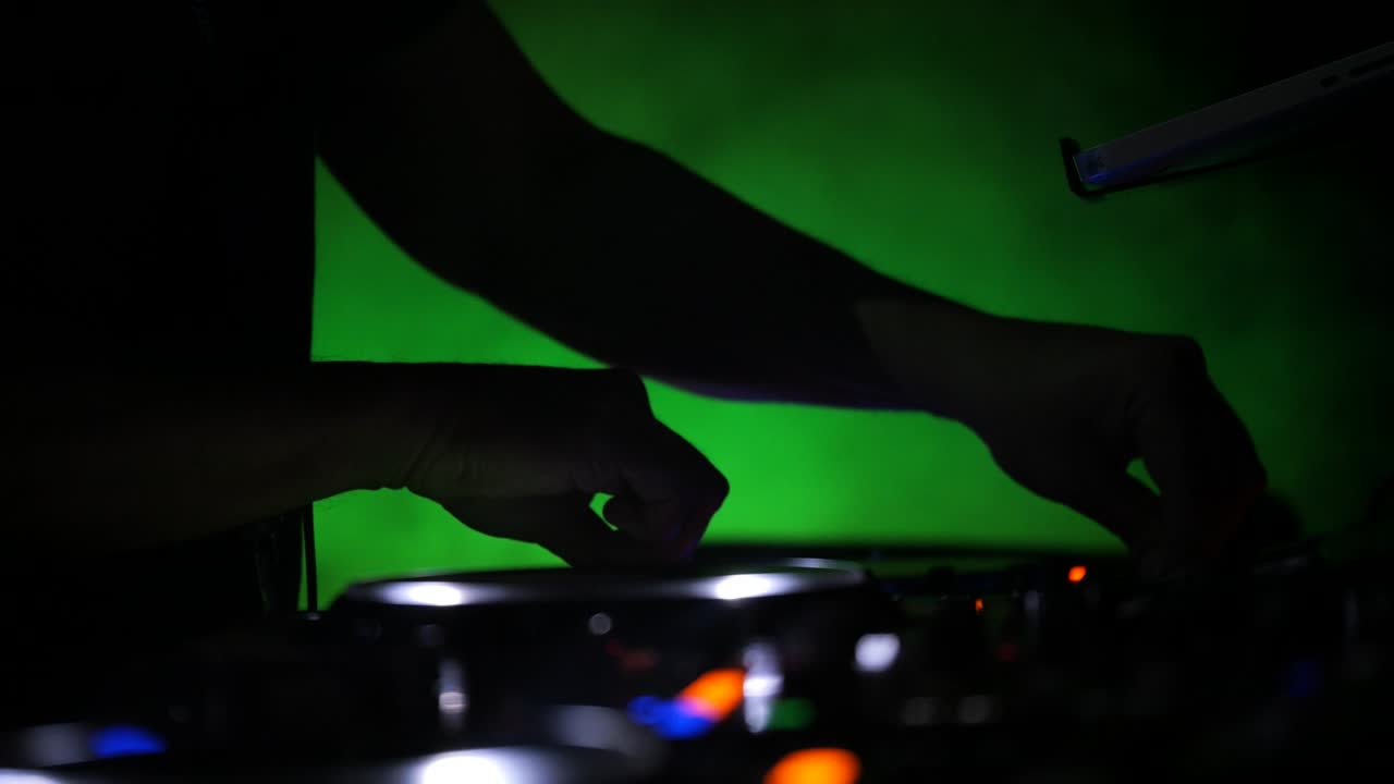 Close-up DJ booth with colorful strobing lights
