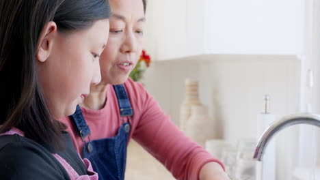 Child-washing-her-hands-with-her-mother