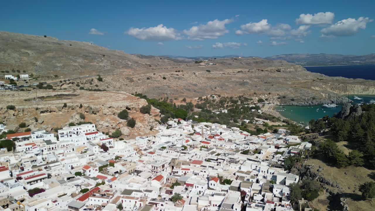 Lindos clockwise rotate and flyover, revealing bay, Aerial drone, Rhodes, Greece