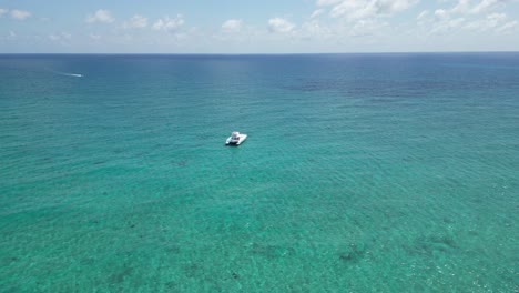 Aerial-wide-sht-of-a-catamaran-in-the-middle-ofs-turquoise-waters-near-Saona-Island,-at-the-Dominican-Republic