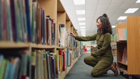 woman selecting a book from a library bookshelf