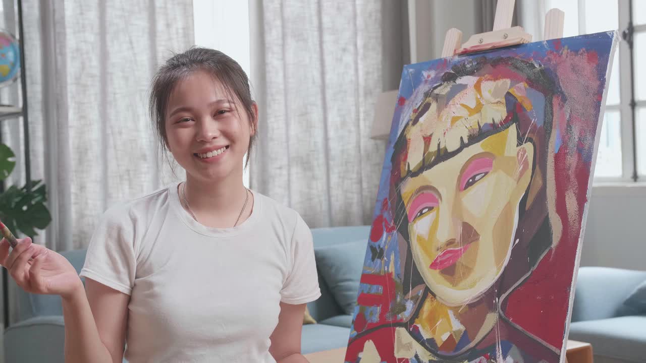 Young Woman Artist Painting a Portrait at Home