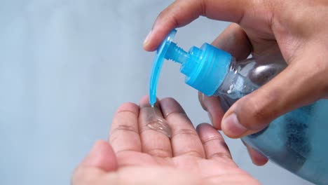 applying hand sanitizer