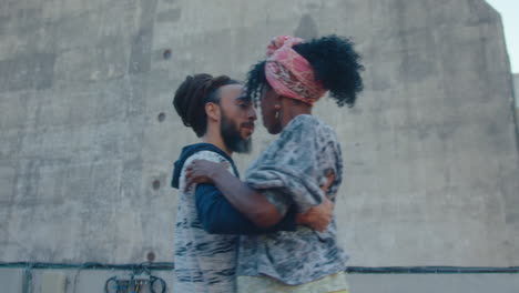 sensual man and woman dancing tango on urban roof during daytime