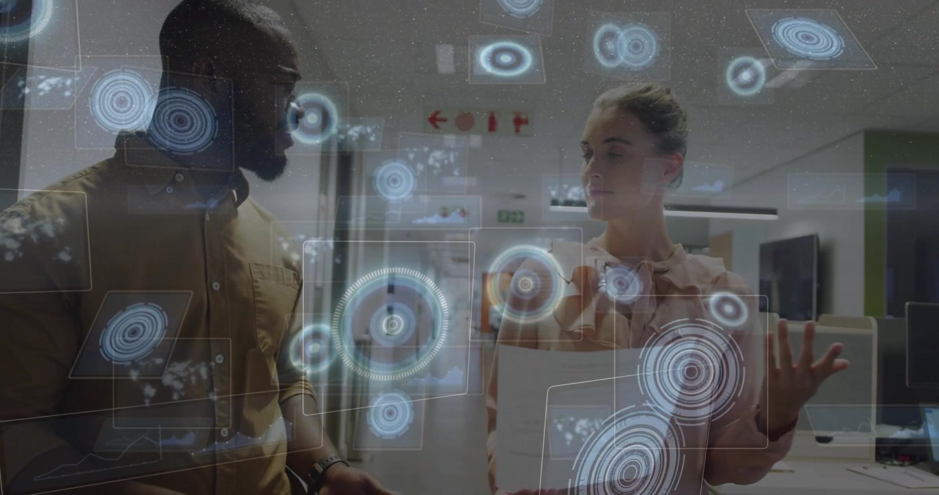 Coworkers reviewing report, man pointing and AR graphics emerging showing business data