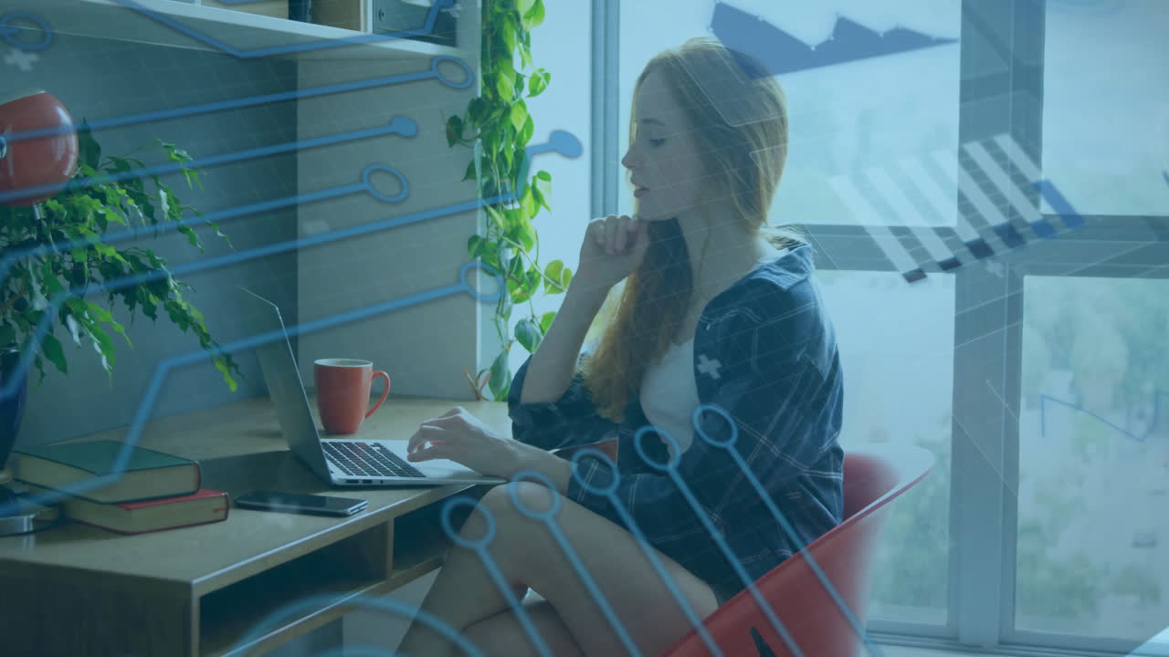 Animation of graphs and circuit board pattern over beautiful caucasian woman working on laptop