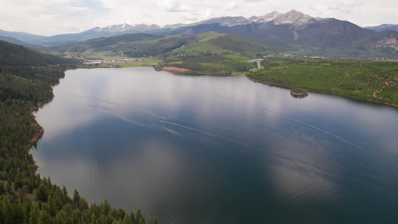 Aerial footage of Dillon Reservoir near Frisco Colorado. Camera is static and shows a calm reservoir with mountains in the background.