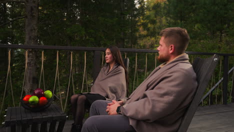 couple enjoying a relaxing day on a deck in the forest