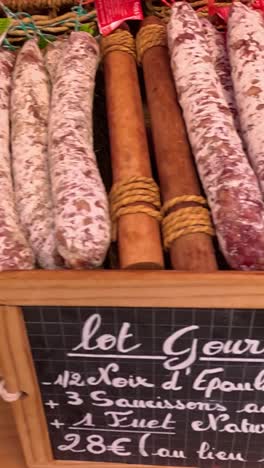 variety of sausages displayed at a market stall