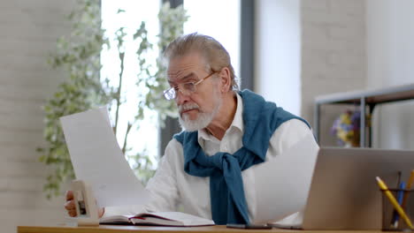 Senior Man Reviewing Documents at Home