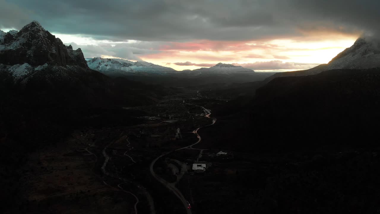 Stunning Aerial Pull away shot of the snow covered mountains of Zion National park