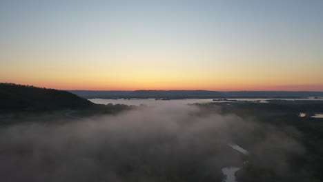 sunrise over a misty river valley