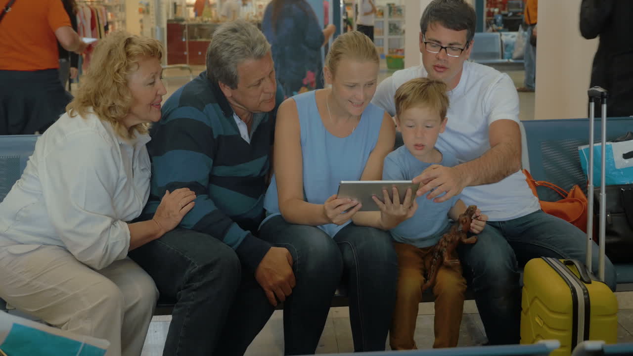 Big Family with Tablet in Waiting Room